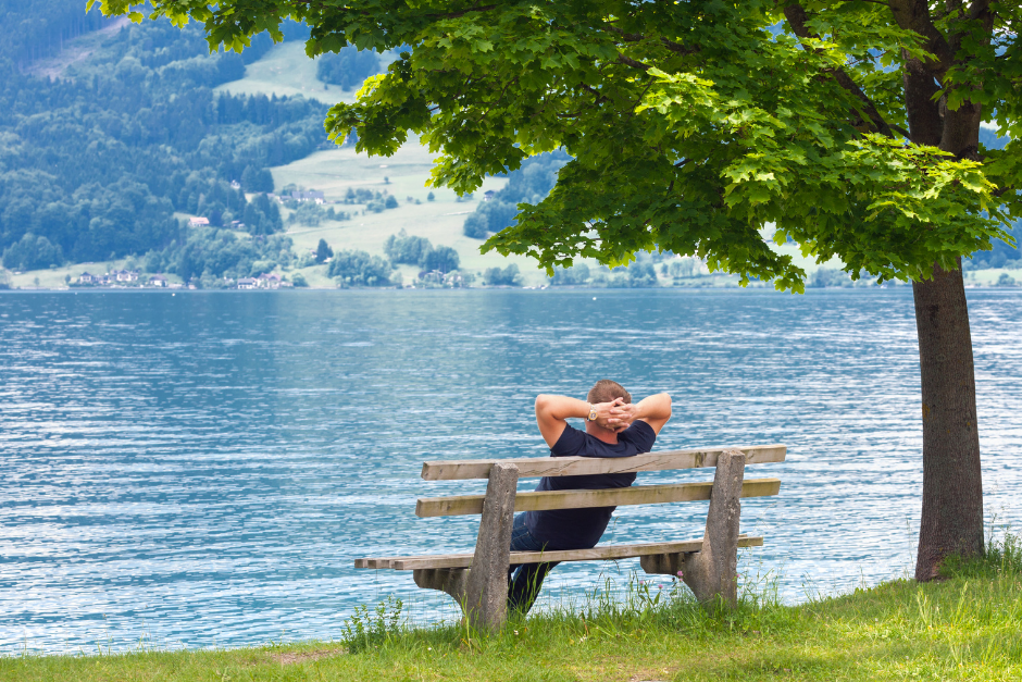 Man on a bench by a lake