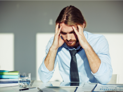 Man looking stressed at his desk
