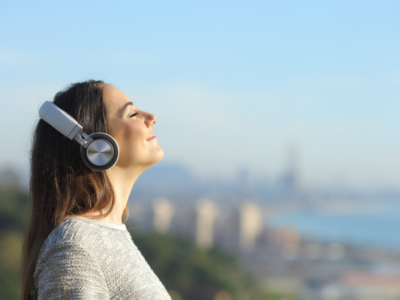Woman listening to music at the beach