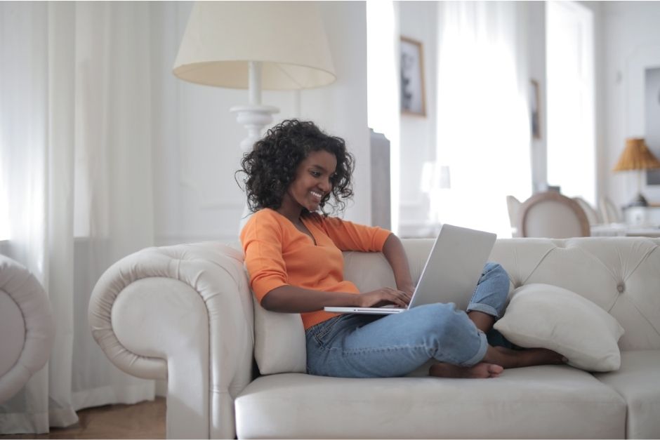 Woman on couch with her computer