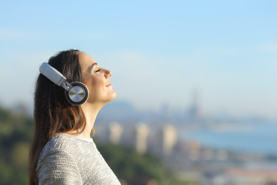 Woman listening to music at the beach
