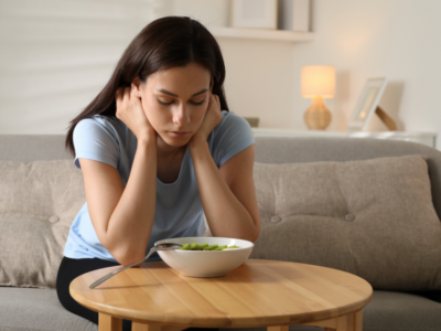 Woman looking sadly at food