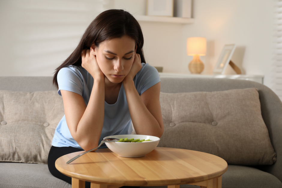 Woman looking sadly at food