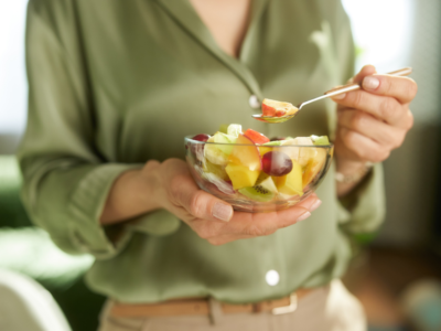 woman eating a fruit salad