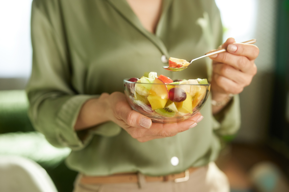woman eating a fruit salad