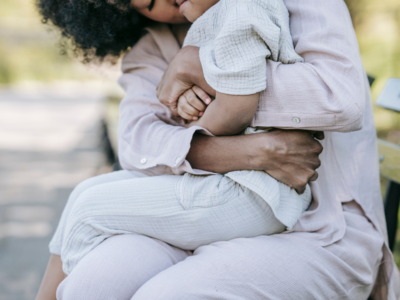 Adult hugging child on her lap