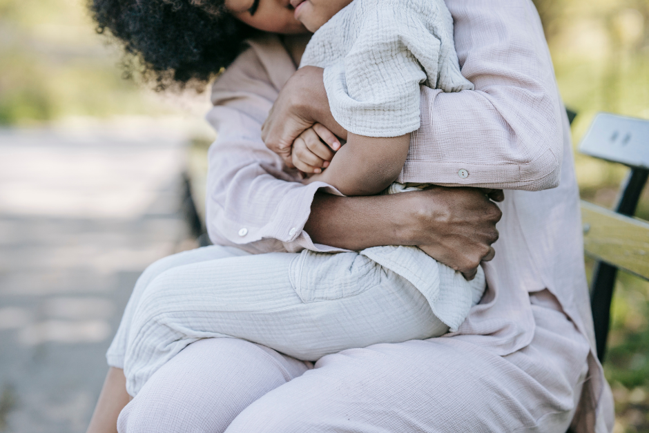 Adult hugging child on her lap