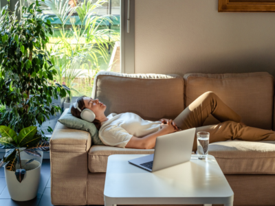 woman relaxing on couch near computer