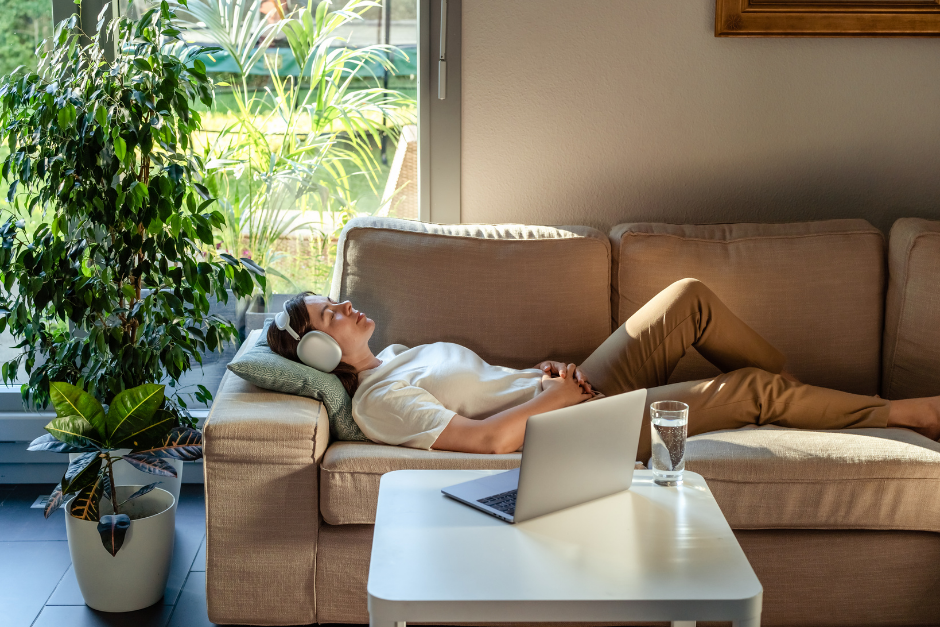 woman relaxing on couch near computer