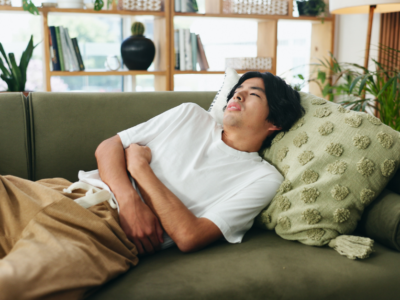 Man on couch with stomach ache