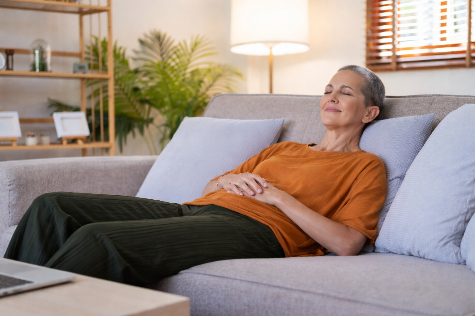 Woman reclining on her couch with closed eyes